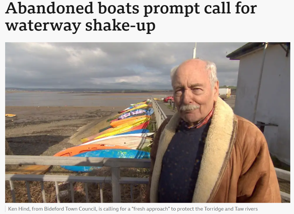 Ken Hind pictured with abandoned boats on the riverside at Bideford